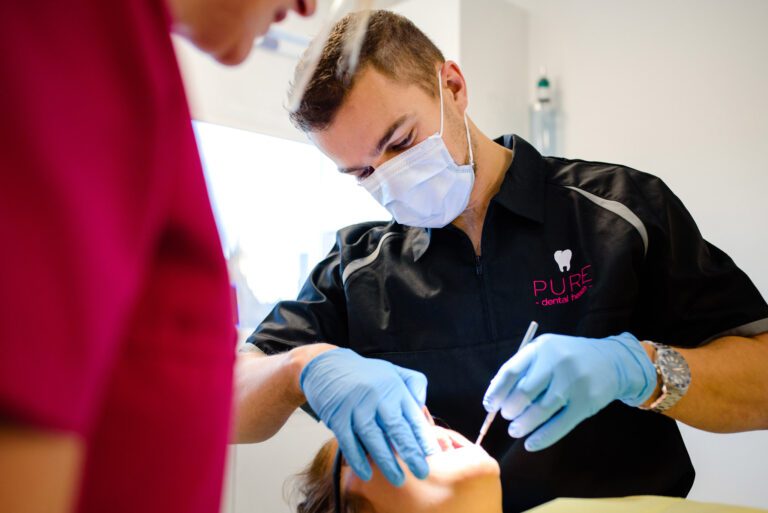 Pure Dental Dentist Treating Patient for a tooth filling