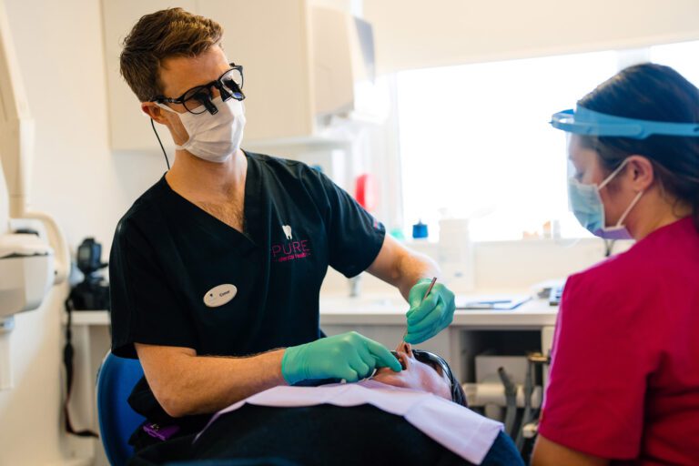 Pure Dental Dentist Performing Filling Treatment