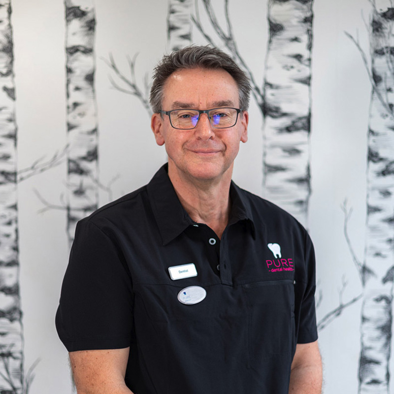 A headshot of dentist Mike Bassett-Cross at Pure Dental.