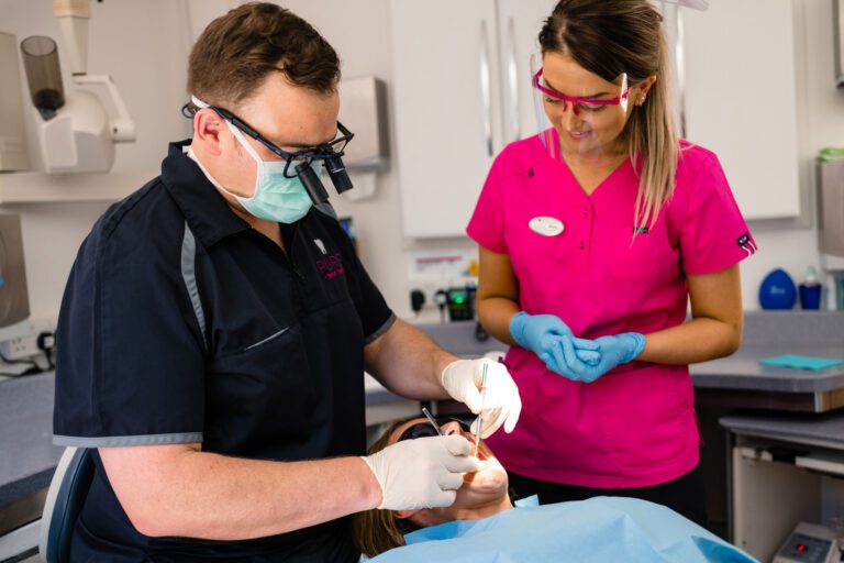 Pure Dental Looking At Patients Teeth