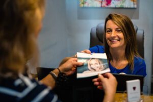 Pure Dental Receptionist Helping Patient