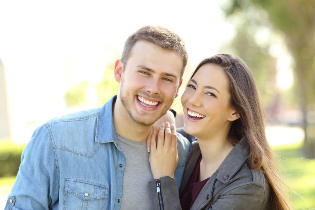 A Couple Smiling With White Teeth